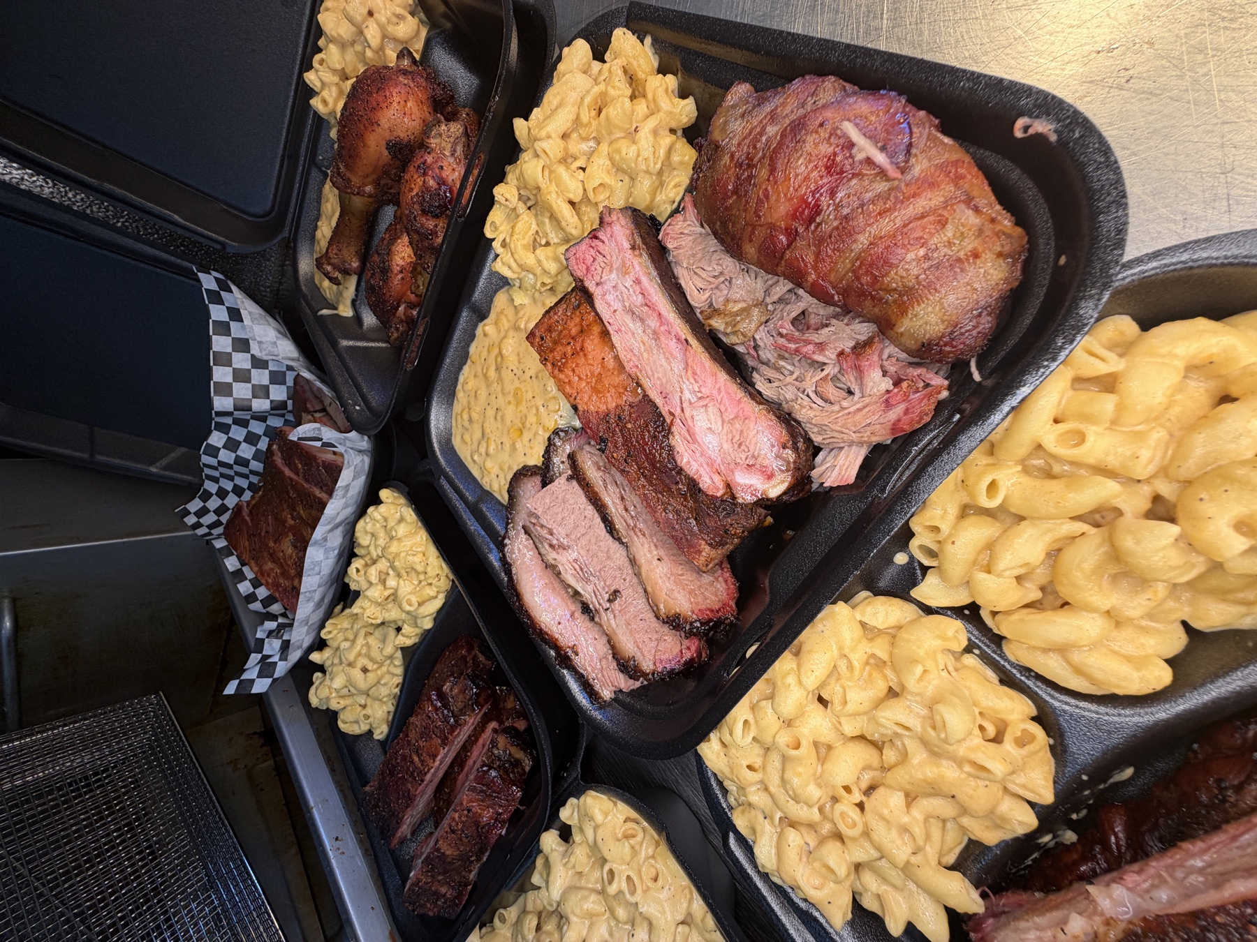 Loaded HNDZ BBQ plates with smoked meats and macaroni and cheese