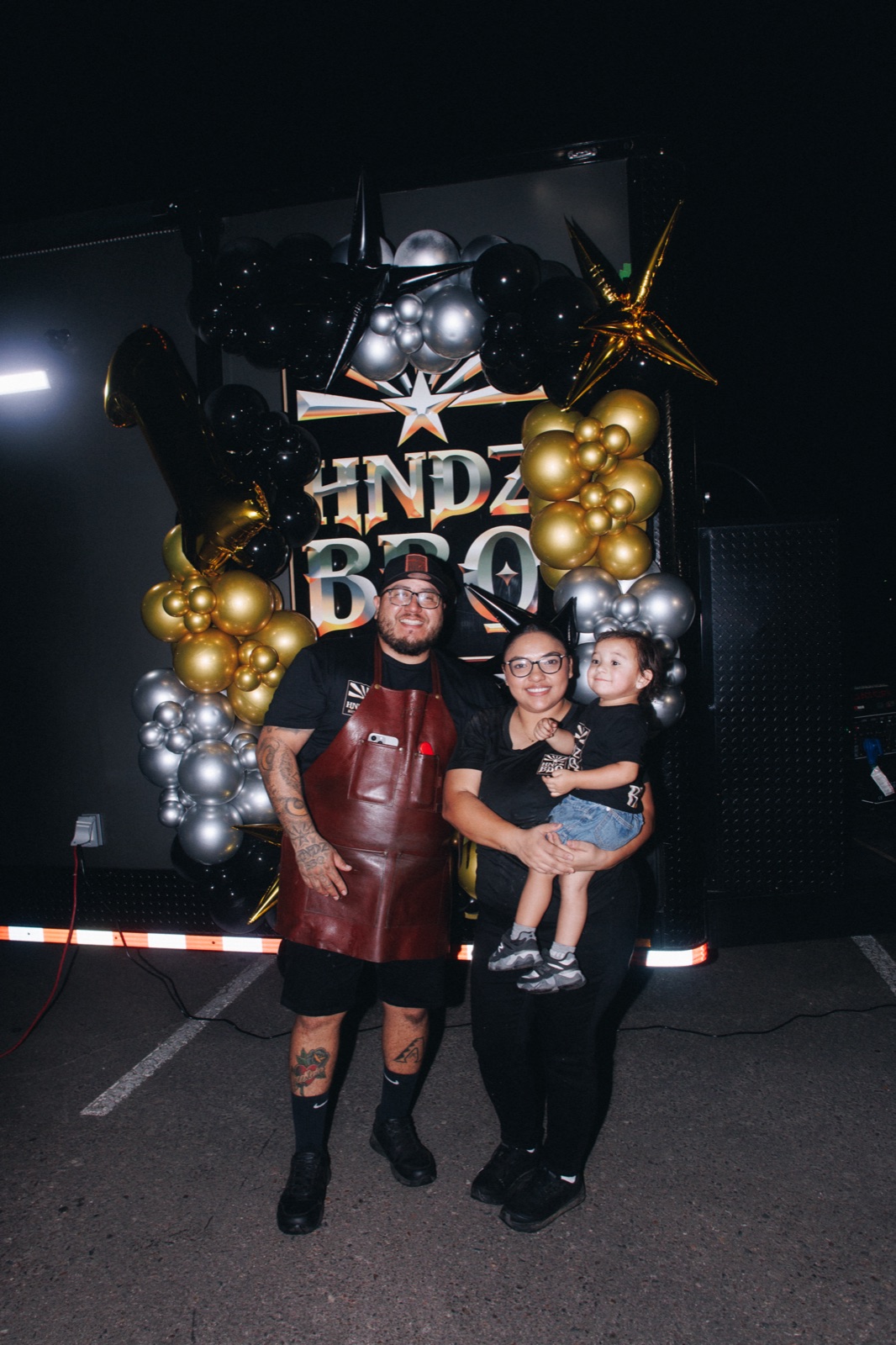 The HNDZ BBQ family celebrating beside their food truck