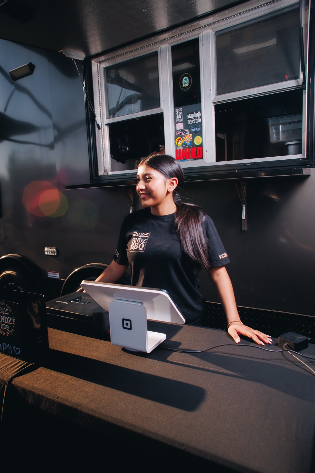 HNDZ BBQ team member welcoming customers at the service counter