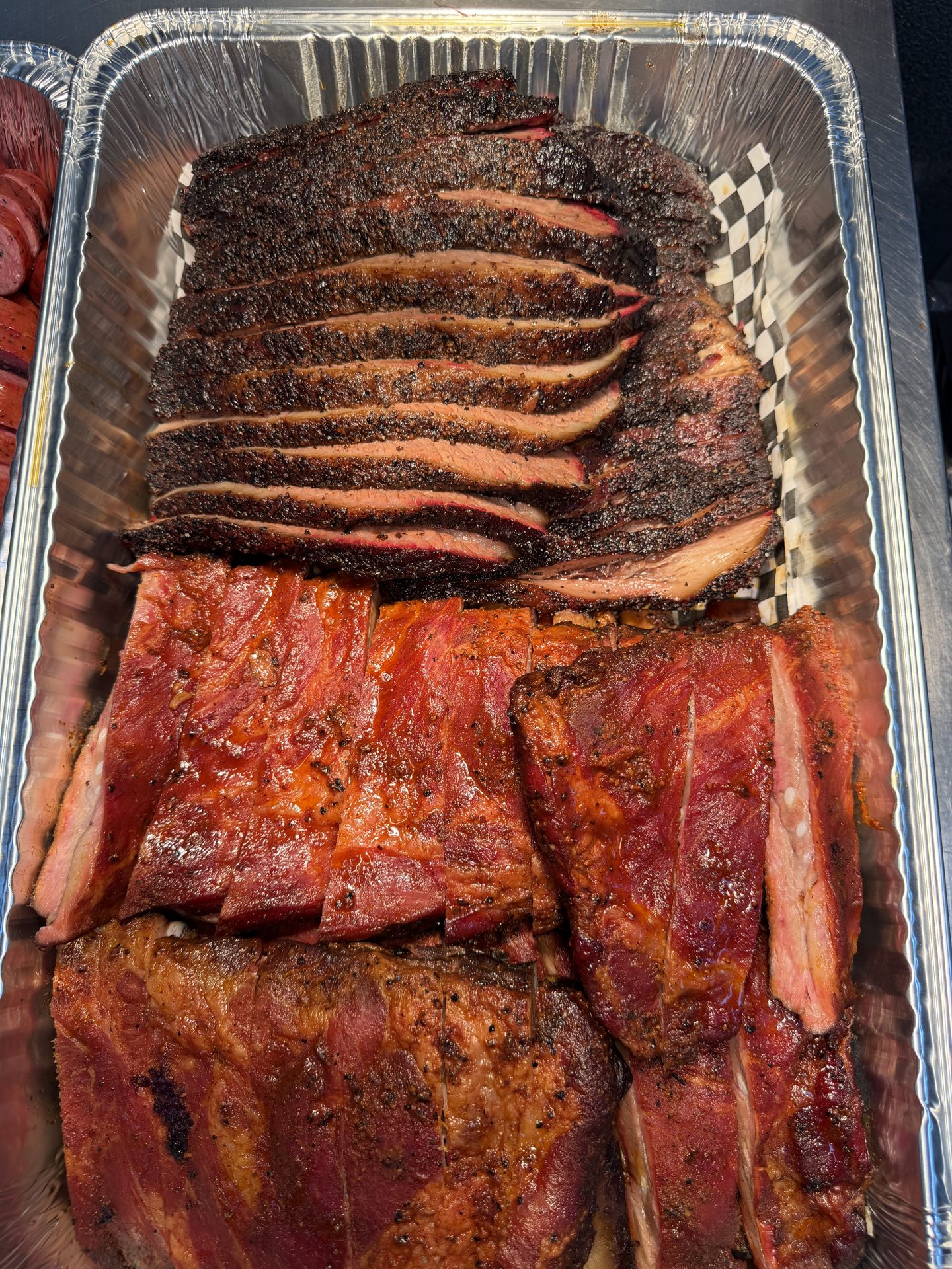 A loaded catering tray of smoked brisket